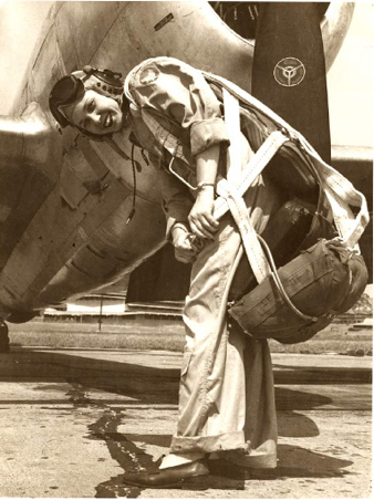 WASP Deanie Bishop Parrish in flight suit, putting on her parachute