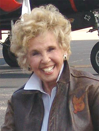 Deanie Bishop Parrish in an A2 leather flight jacket from WWII, sitting in front of an A-26
